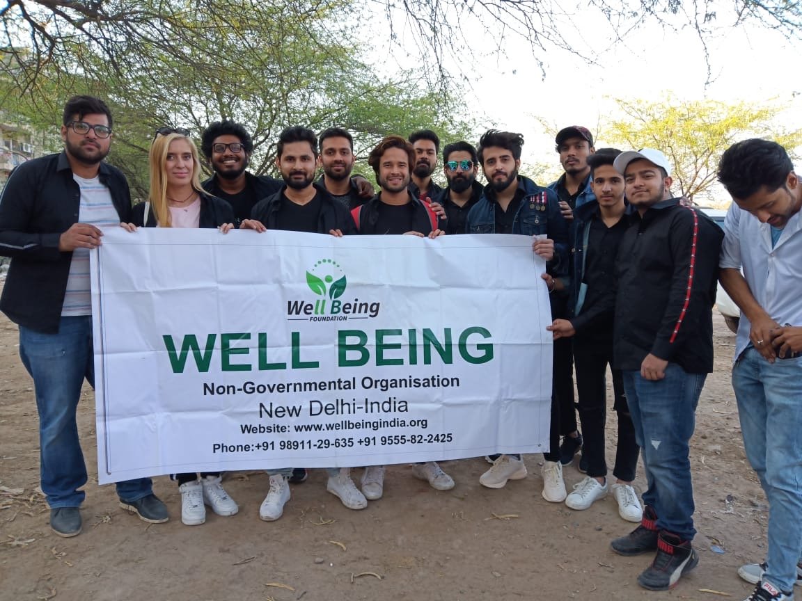 Well Being Foundation team holding the organization banner